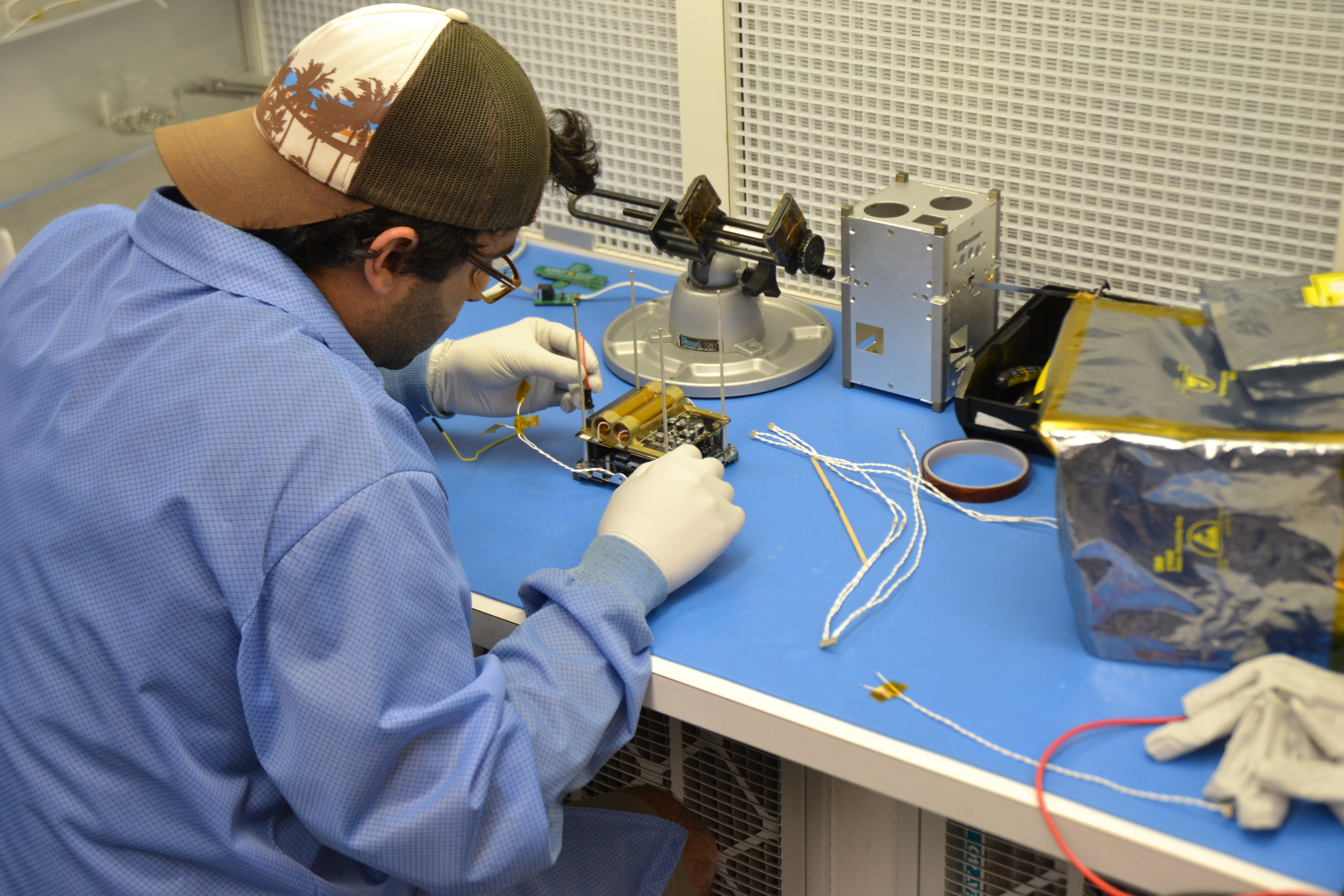 Student assembling electronics stack of a CubeSat